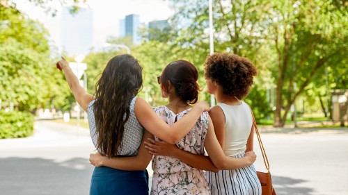 Image of three people outside holding each other as they want down the road, respresenting the importance of support groups with Lichen Sclerosus.