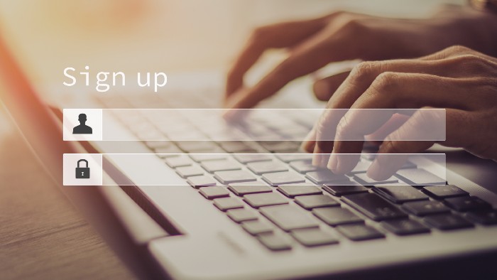 Image of a person's hands, typing on a keyboard. Above the keyboard is the text, 'sign up now' and another text box reads 'subscribe to The Lost Labia Chronicles'.