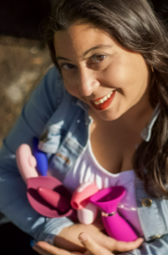 Image of Celina holding various intimacy toys. Celina is a great resource for sex and intimacy with lichen sclerosus.