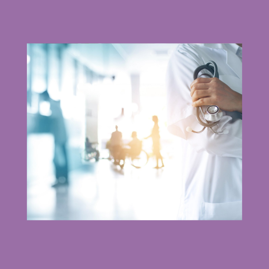 Blurred, bright image of a medical office, with a person in a long white lab coat at the forefront. Only their shoulder down to their hips is in the frame. They have their arms folded across their chest and grip a stethoscope in one hand. The image has a purple medium-thickness border. The image represents anxiety that can occur due to perceived medical or health conditions.
