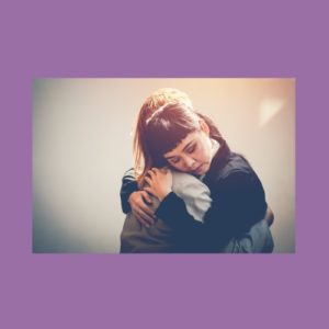 Image of two people hugging each other, bonding over living with ls and trauma and knowing how hard it can be.