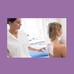 Image of a doctor administering a patch test on the back of a patient with pale skin and blonde hair.